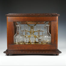 Load image into Gallery viewer, Antique Black Forest Liquor Tantalus Carved Wood Cabinet Box Caddy Victorian Engraved Crystal Decanters & Cordial Glasses