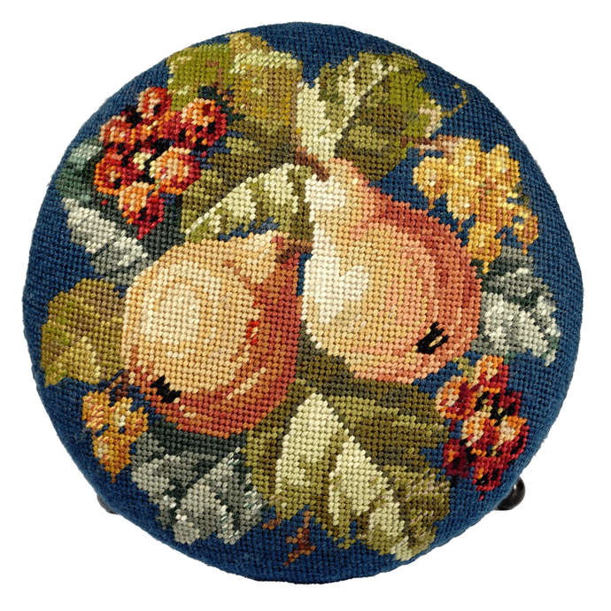 Decorative needlepoint pillow with pears and flowers on a blue background